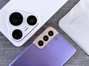 Close-up of two smartphones with camera focus on a textured wooden surface. jigsaw puzzle