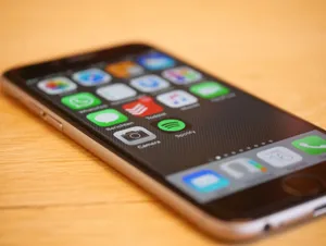 Close-up of a smartphone showcasing multiple app icons on its screen, representing modern technology and connectivity. jigsaw puzzle