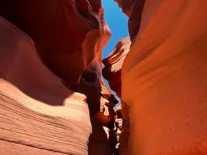 Capture the breathtaking curves and shadows of a sandstone slot canyon on a clear day. jigsaw puzzle