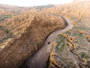 Stunning aerial view of Ak Say Canyon showcasing its rugged landscape and winding river. jigsaw puzzle
