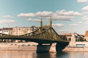 Sunlit Liberty Bridge in Budapest spans the Danube, showcasing urban architecture and cityscape. jigsaw puzzle