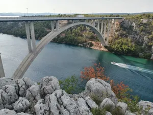 A serene view of the arch bridge spanning the Krka River in Skradin, Croatia. jigsaw puzzle
