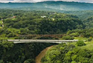 Stunning aerial shot of dual bridges over a river in the green, mountainous valley of Concepción, Costa Rica. jigsaw puzzle