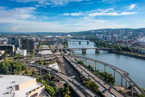 Aerial view of Portland cityscape featuring bridges over a river and urban landscapes on a clear day. jigsaw puzzle