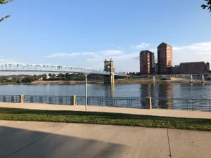 Serene view of Cincinnati's John A. Roebling Suspension Bridge over the Ohio River under clear skies. jigsaw puzzle