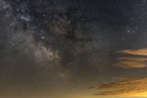 Breathtaking view of a starry night sky featuring the Milky Way and wispy clouds. jigsaw puzzle