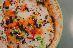 Close-up of vibrant ice cream topped with colorful sprinkles in a decorative bowl. jigsaw puzzle