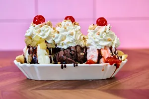 Indulge in a classic banana split topped with cherries, whipped cream, and chocolate sauce. jigsaw puzzle