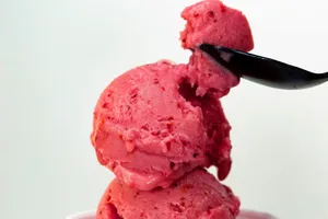 Delicious strawberry ice cream scoop with a spoon on a bright background. jigsaw puzzle
