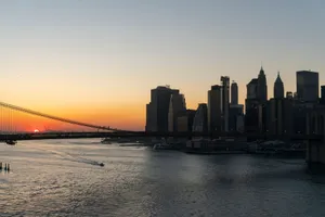 Stunning view of Brooklyn Bridge and Manhattan skyline captured during sunset over the New York City waterfront. jigsaw puzzle
