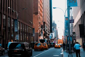 Vibrant city street in New York with taxis, tall buildings, and pedestrians. jigsaw puzzle