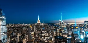 A breathtaking view of New York City's skyline illuminated at night. jigsaw puzzle