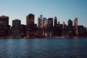 Captivating view of the New York City skyline with skyscrapers reflected in the water at dusk. jigsaw puzzle