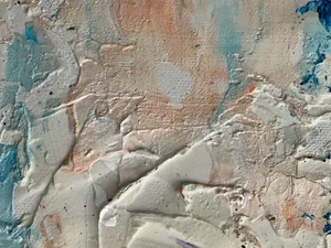 Close-up of a textured wall showing layers of colorful paint in an abstract pattern. jigsaw puzzle