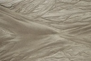 Close-up view of abstract sand formations resembling waves or dunes, showcasing natural textures. jigsaw puzzle