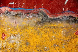 Abstract close-up of a wall with cracked red and yellow paint creating a rugged texture. jigsaw puzzle