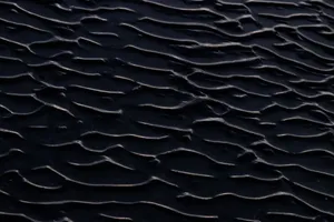 Close-up view of dark sand ripples creating a unique abstract texture pattern. jigsaw puzzle