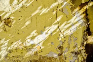 Sunlit shadows on a textured, peeling yellow wall in Fès, Morocco. jigsaw puzzle