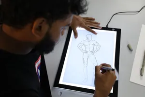 Illustrator sketching a superhero figure on a digital lightboard in an art studio setting. jigsaw puzzle
