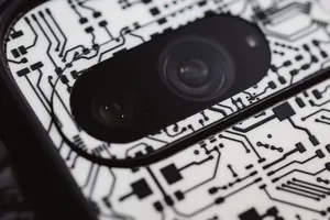 Macro shot of an electronic circuit design around a smartphone camera lens, showing intricate details. jigsaw puzzle