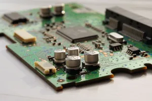 Detailed view of a green circuit board featuring capacitors and microchips. jigsaw puzzle