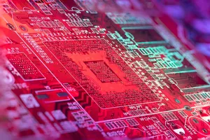 Red printed board of digital device with bright electric circuit with numbers and symbols placed in room on blurred background jigsaw puzzle