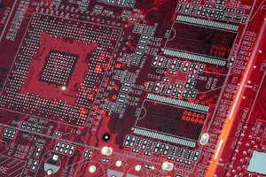 Detailed shot of a red motherboard showcasing electronic components and circuits. jigsaw puzzle