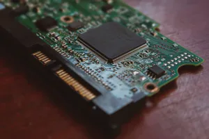 Detailed shot of a computer circuit board showing components and golden pins. jigsaw puzzle