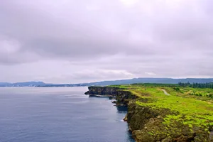 Explore the breathtaking coastal cliffs of Okinawa, showcasing lush greenery and the ocean. jigsaw puzzle