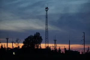 Silhouette of communication towers against a vibrant sunset sky with clouds. jigsaw puzzle