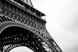 Close-up view of the Eiffel Tower showcasing intricate ironwork in black and white. jigsaw puzzle