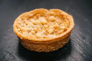 A mouth-watering apple crumble tart on a dark slate background. jigsaw puzzle