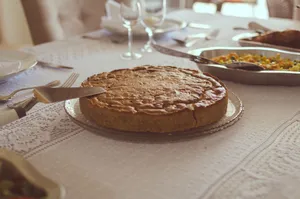 Delicious homemade pie served on a beautifully set table in Brasília. Perfect for a warm meal. jigsaw puzzle