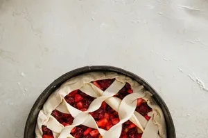 Overhead view of an unbaked cherry pie with a lattice crust on a floured surface. jigsaw puzzle