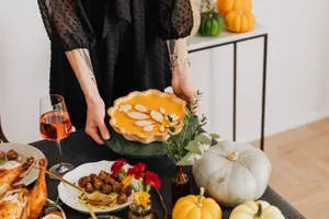 A warm Thanksgiving setup featuring pumpkin pie and festive decor for a cozy celebration. jigsaw puzzle