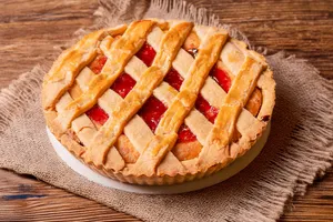 A mouthwatering strawberry lattice pie on a rustic wooden table in Lima, Perú. jigsaw puzzle