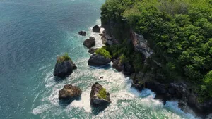 Stunning aerial view of a rocky coastline with lush greenery in Bali, Indonesia. jigsaw puzzle