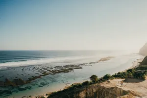 A stunning aerial view of Bali's coastline with clear blue waters and rugged cliffs. jigsaw puzzle