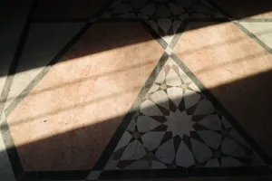 Sunlight casts shadows on a geometric tile floor in Aleppo, Syria, creating an artistic display. jigsaw puzzle
