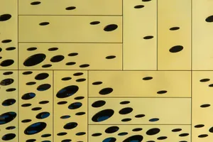 Close-up of a modern yellow wall with unique circular cutouts creating an abstract design. jigsaw puzzle
