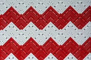 Decorative red and white zigzag pattern with geometric tiles creating a bold visual design. jigsaw puzzle