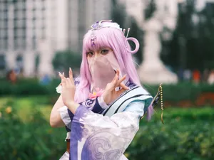 Cosplay enthusiast poses in colorful attire with lavender hair outdoors in Vietnam. jigsaw puzzle