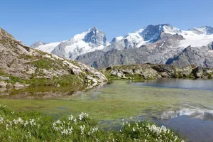 Picturesque view of snowcapped mountains and serene lake at La Grave, France. jigsaw puzzle