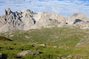 Scenic view of rugged mountains and grassy fields in Briançon, Provence-Alpes-Côte d'Azur. jigsaw puzzle