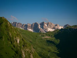 Scenic view of lush green valleys and snow-capped peaks in Morzine, France. jigsaw puzzle