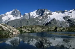 Scenic view of snow-covered mountains and lake reflection in La Grave, France. jigsaw puzzle
