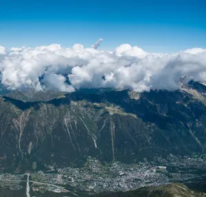 Breathtaking aerial view of Chamonix Valley and mountains under a vibrant blue sky with clouds. jigsaw puzzle