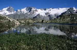 Majestic snow-capped mountains and a serene lake reflection in La Grave, France. jigsaw puzzle