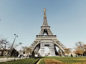 Low angle shot of the Eiffel Tower in Paris with blue sky and partial park view. jigsaw puzzle