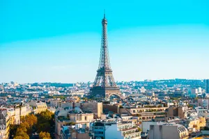 A breathtaking view of the Eiffel Tower amidst the Paris cityscape under a clear blue sky. jigsaw puzzle